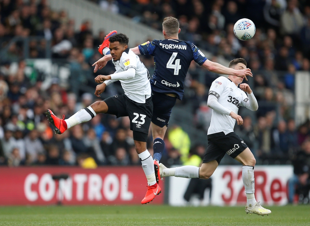 Derby County's Duane Holmes in action with Leeds United's Adam Forshaw during the  Championship playoff semifinal first leg at the Pride Park, Derby, Britain, on Saturday. — Reuters