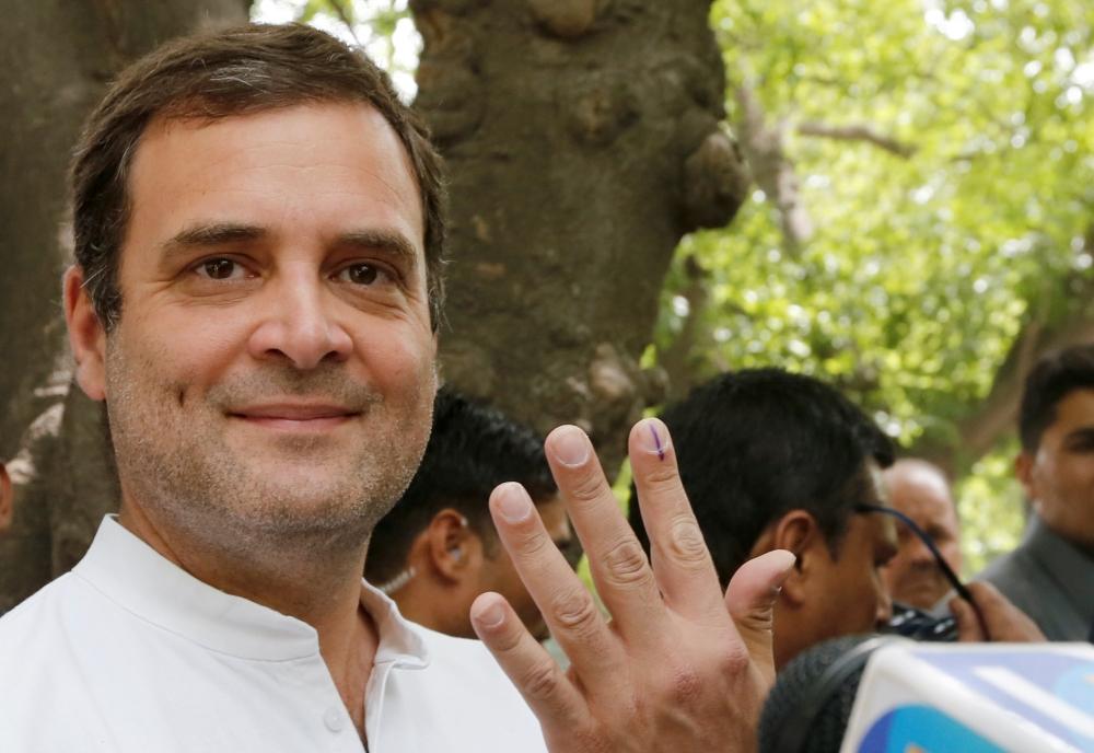 Rahul Gandhi, president of India's main opposition Congress party, shows his ink-marked finger after casting his vote at a polling station in New Delhi, India on May 12. Reuters