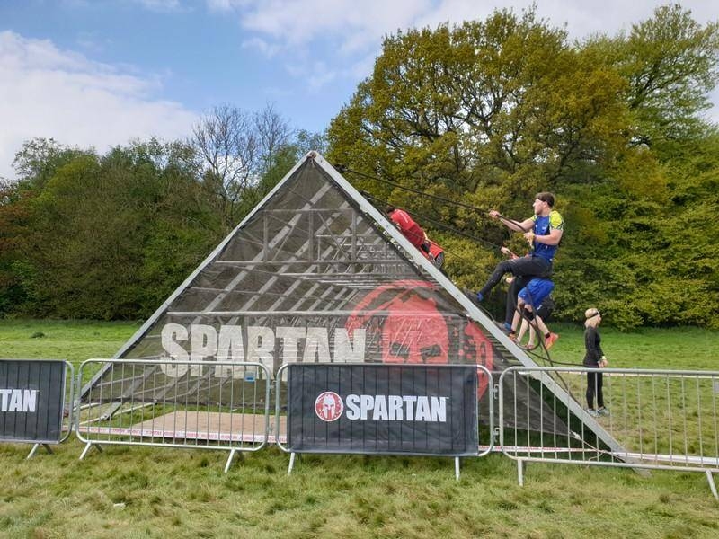 Participants scale a triangular obstacle at the Spartan obstacle course race (OCR) in Wrotham, Kent, Britain in this May 5, 2019 file photo. — Reuters