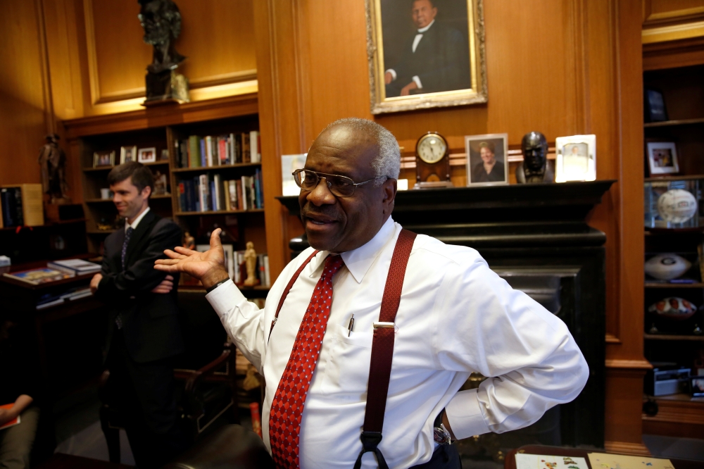 US Supreme Court Justice Clarence Thomas talks in his chambers at the US Supreme Court building in Washington in this June 6, 2016 file photo. — Reuters