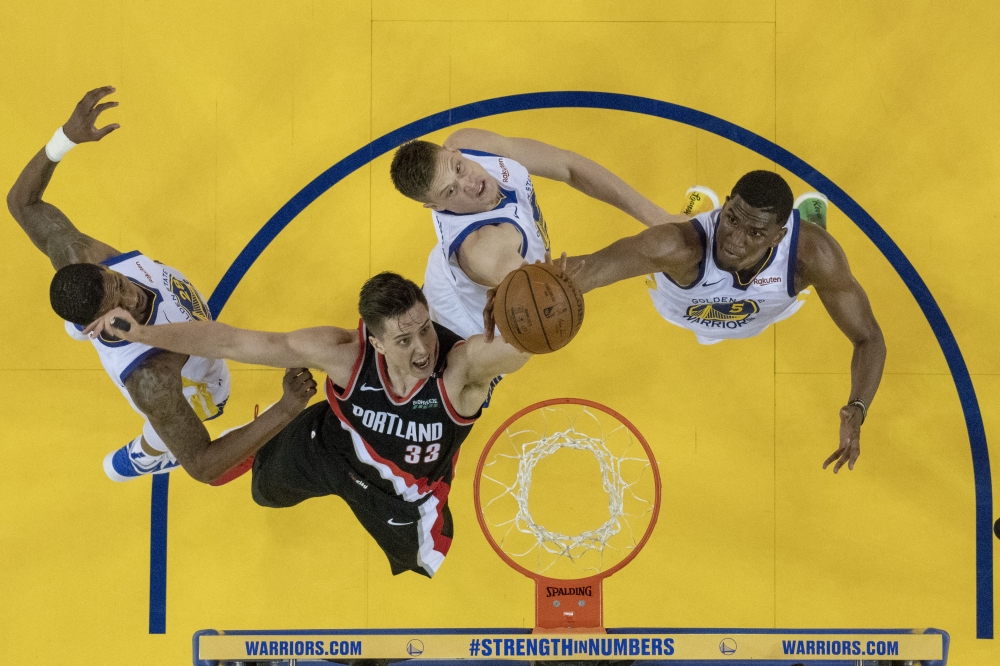 Portland Trail Blazers forward Zach Collins (33) fights for the rebound against Golden State Warriors forward Alfonzo McKinnie (28), forward Jonas Jerebko (21), and center Kevon Looney (5) during the second half in game one of the Western conference finals of the 2019 NBA Playoffs at Oracle Arena in this May 14, 2019 file photo. — Reuters