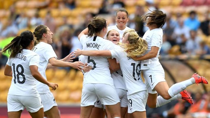 CJ Bott is swarmed by Football Ferns teammates after scoring a spectacular goal against Argentina in this file photo. — AFP