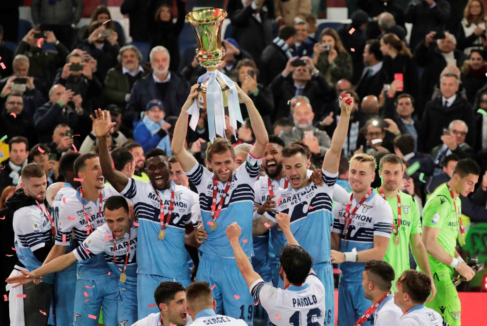 Lazio team members celebrate with the trophy after winning the Coppa Italia against Atalanta at the Stadio Olimpico, Rome, Italy, on Wednesday. — Reuters