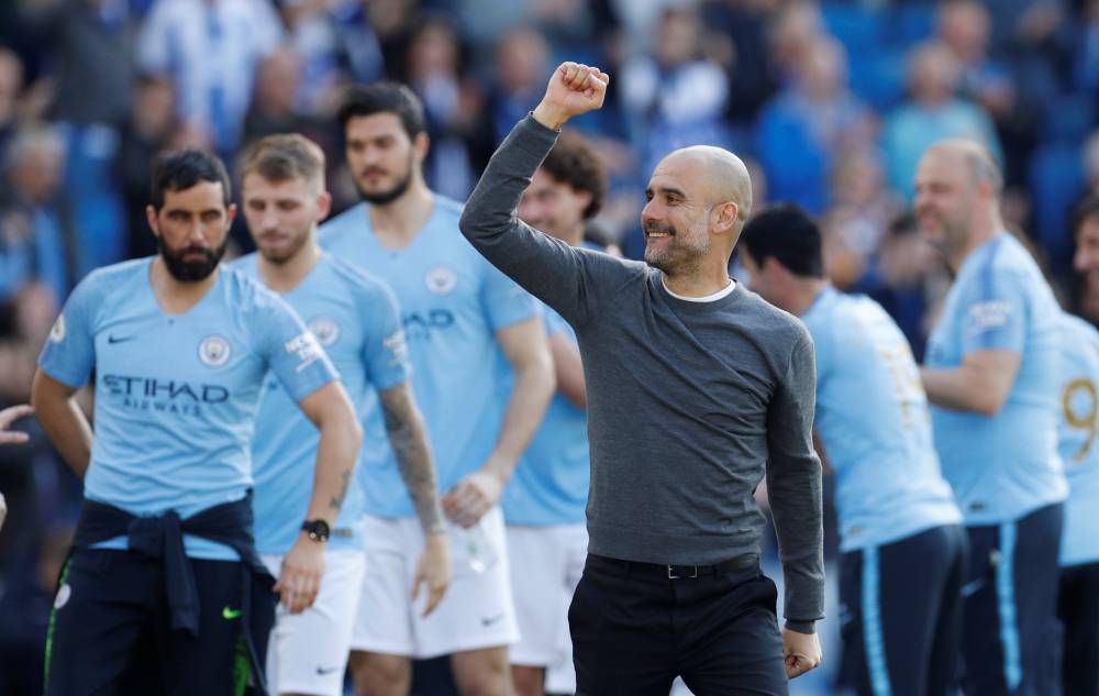 Manchester City manager Pep Guardiola celebrates winning the Premier League after beating Brighton & Hove Albion at the The American Express Community Stadium, Brighton, Britain, on Sunday.  — Reuters