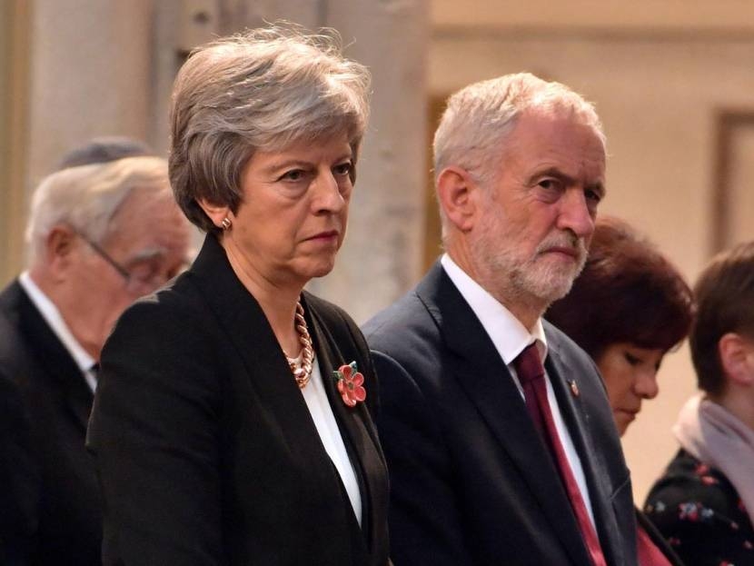 Britain's Prime Minister Theresa May and the leader of opposition Labor Party Jeremy Corbyn attend an Armistice remembrance service at St Margaret's Church, London, on Nov. 6, 2018. — Reuters