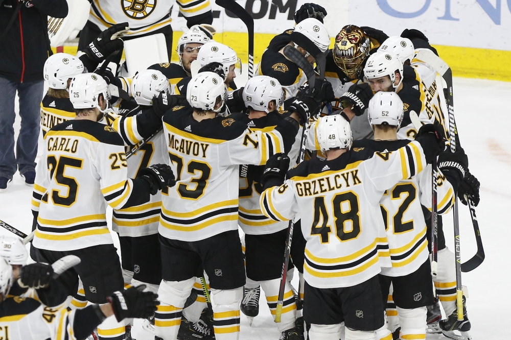 Boston Bruins goaltender Tuukka Rask (40) is mobbed by teammates after the Bruins game against the Carolina Hurricanes in game four of the Eastern Conference Final of the 2019 Stanley Cup Playoffs at PNC Arena. The Bruins won the game 4-0, and clinched the Eastern Conference championship. — Reuters