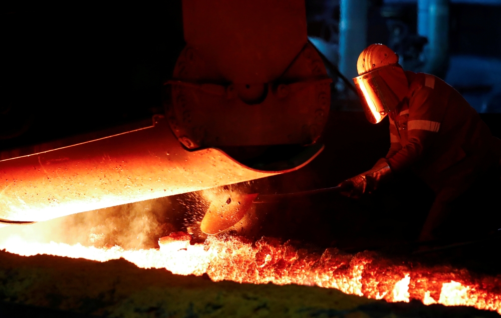 Workers of German steel maker ThyssenKrupp AG protest in a warning strike organized by German union IG Metall for higher wages at the ThyssenKrupp steel Europe plant of Dortmund, Germany, in this file photo. — Reuters