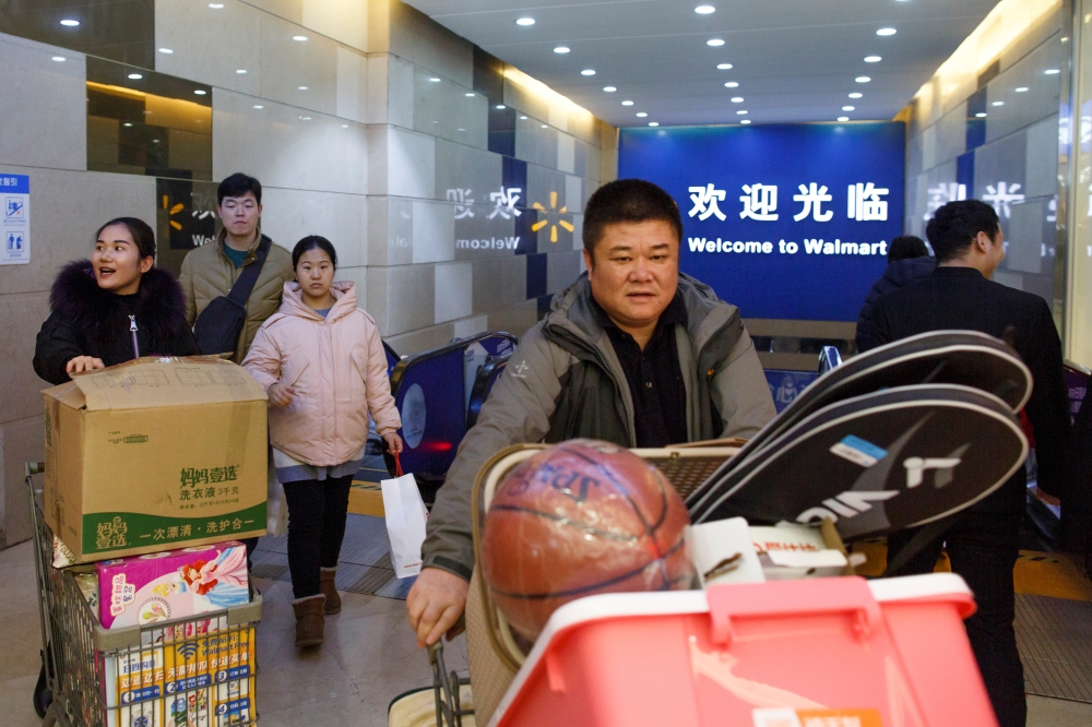 A deliveryman leans against a cart outside a wholesale market in central Zhengzhou, Henan province, China, in this file photo. — Reuters