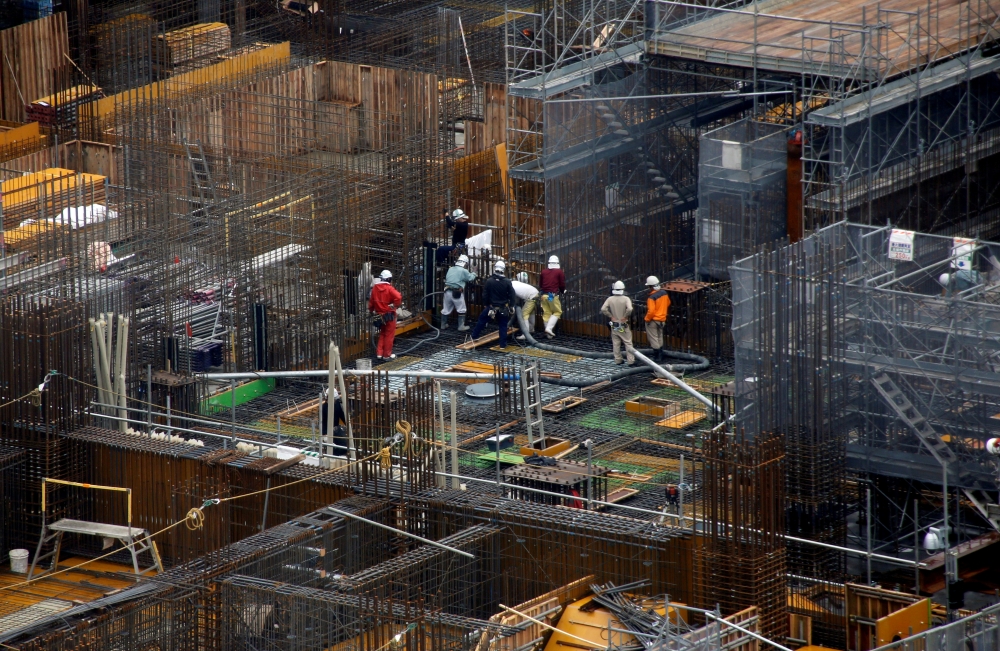 Workers are seen at the construction site of the Athletes' Village for the Tokyo 2020 Olympic Games in Tokyo, Japan, in this file photo. — Reuters