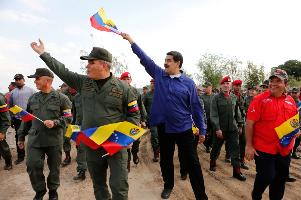 Venezuela's President Nicolas Maduro gestures next to Venezuela's Defense Minister Vladimir Padrino Lopez, during a ceremony at a military base in Maracay, Venezuela May 17. - Reuters