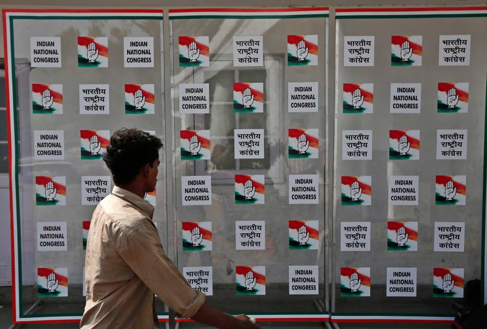 A man walks past the headquarters of India's Congress party in New Delhi May 16. - Reuters