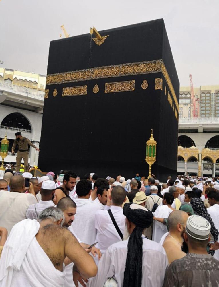 Pilgrims and visitors enjoy welcome showers that blessed the holy city of Makkah on Saturday. — SPA