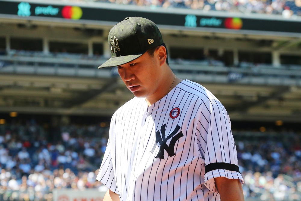 New York Yankees starting pitcher Masahiro Tanaka (19) leaves the field after getting the third out and being hit by a ground ball against the Tampa Bay Rays during the sixth inning at Yankee Stadium. — Reuters