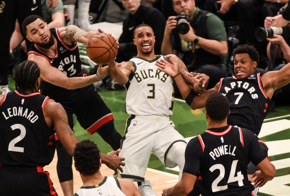 Toronto Raptors guard Fred VanVleet (23) and guard Kyle Lowry (7) fight for a loose ball against Milwaukee Bucks guard George Hill (3) in the fourth quarter in game two of the Eastern conference finals of the 2019 NBA Playoffs at Fiserv Forum in Milwaukee, Wisconsin on Friday. — Reuters