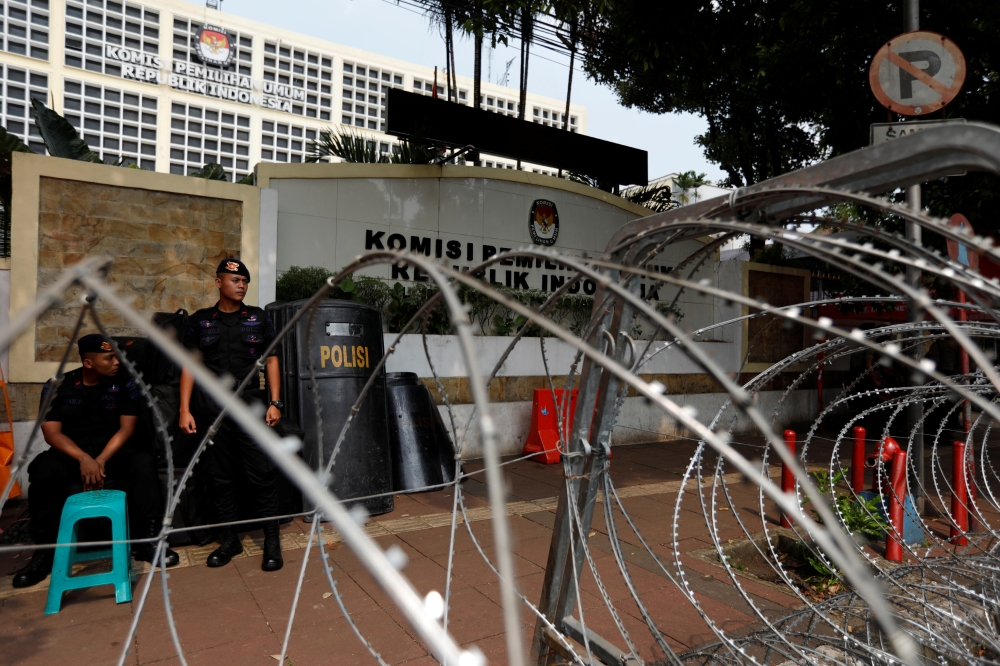 Mobile police brigade officers stand guard outside the General Election Commission (KPU) headquarters ahead of the announcement of the presidential election results after last month's election in Jakarta, Indonesia, May 20. - Reuters