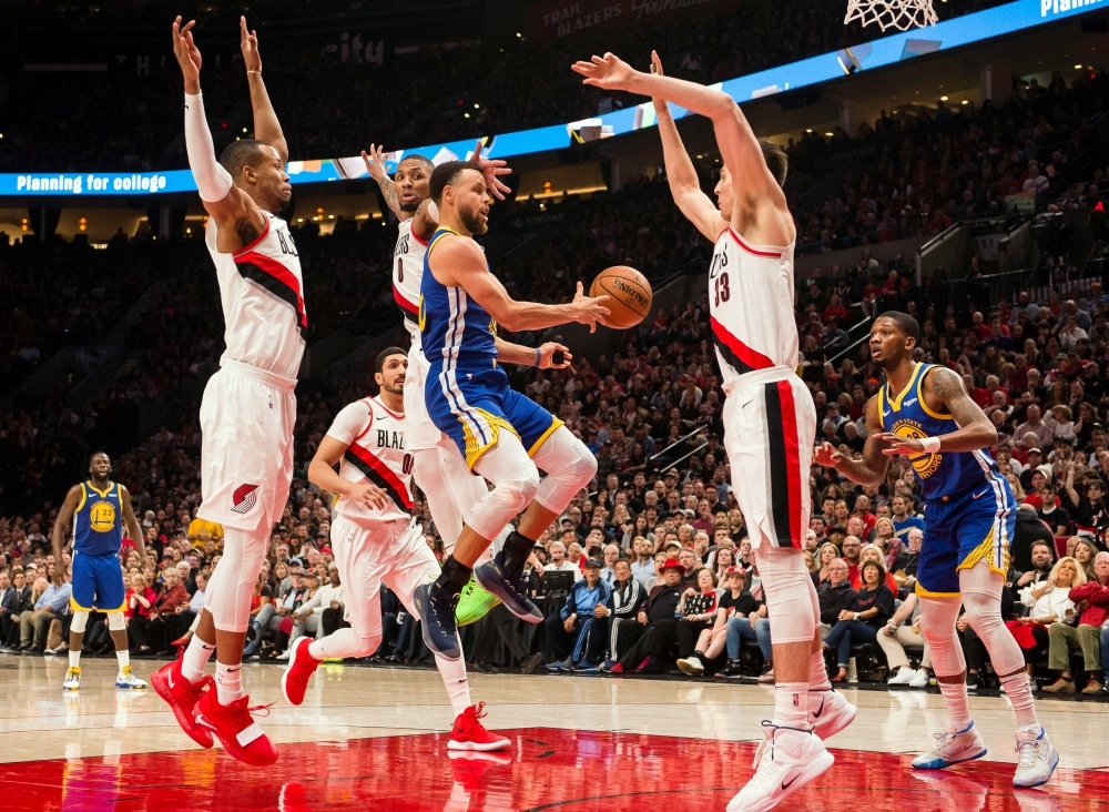 Golden State Warriors guard Stephen Curry (30) passes the ball to teammate Golden State Warriors forward Alfonzo McKinnie (28) during the second half against the Portland Trail Blazers in game three of the Western conference finals of the 2019 NBA Playoffs at Moda Center, on Saturday. The Golden State Warriors beat the Portland Trail Blazers 110-99. — Reuters