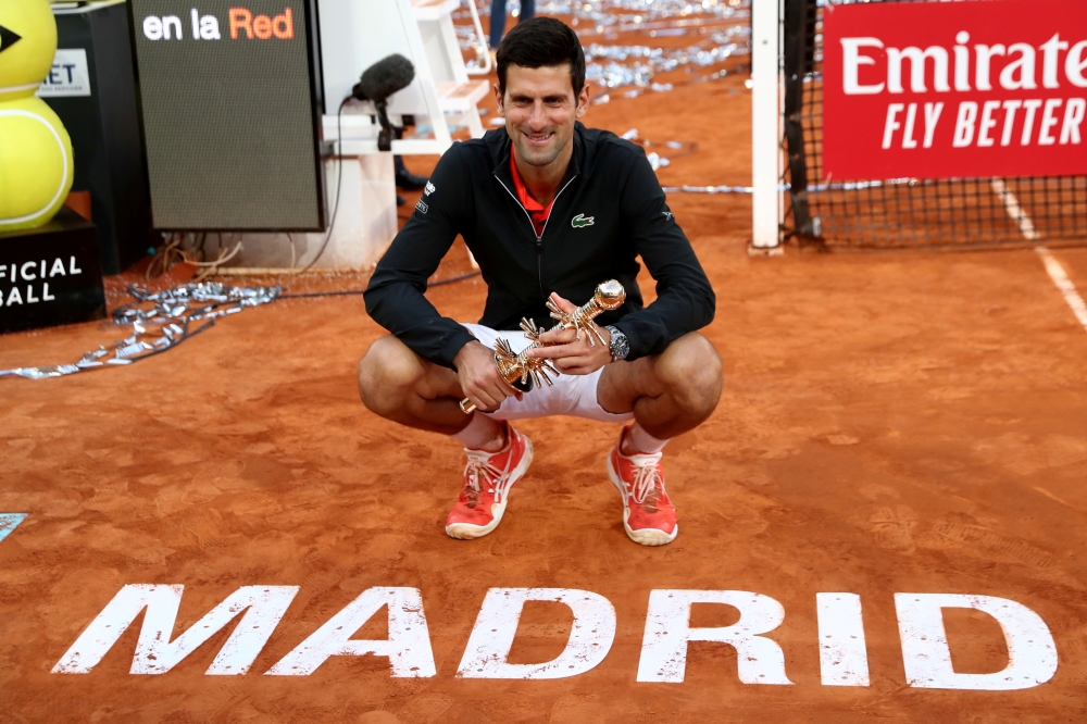 Serbia's Novak Djokovic celebrates with the trophy after winning the Madrid Open final against Greece's Stefanos Tsitsipas in this May 12, 2019 file photo. — Reuters