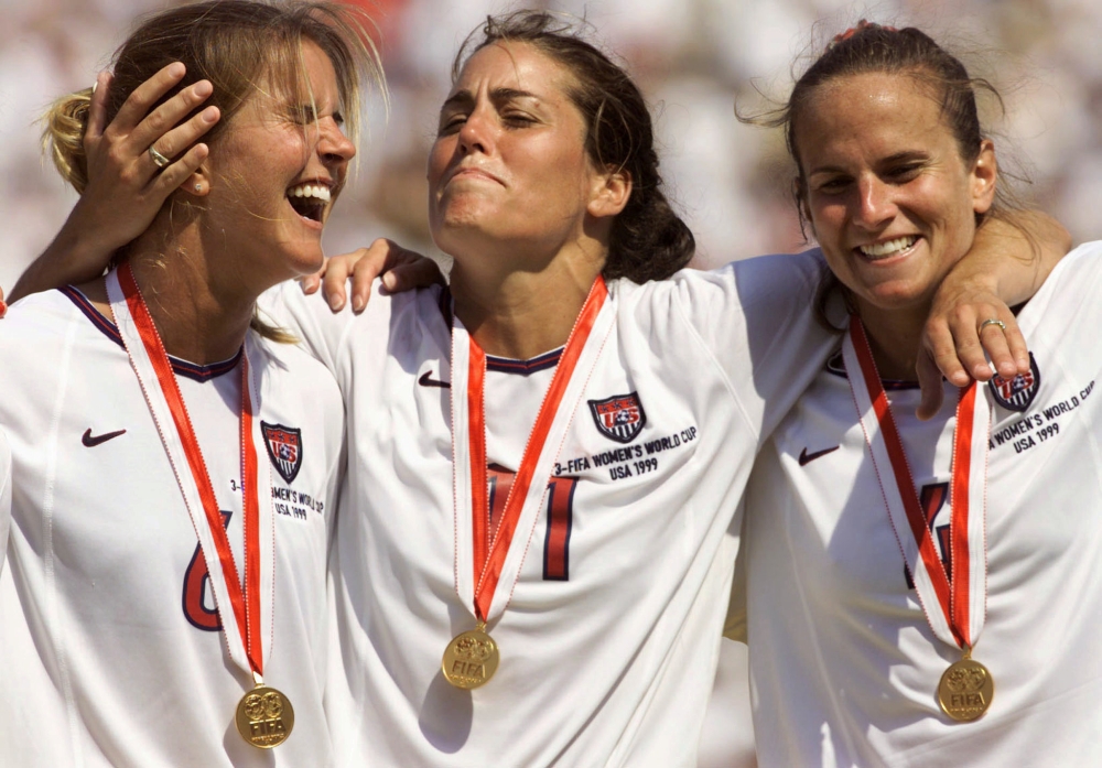 United States Women's World Cup team members Brandi Chastain (L) who scored the winning penalty kick, Julie Foudy (C) and Carla Overbeck celebrate the United States victory against China in the World Cup Final July 10 at the Rose Bowl. The United States won the final 5-4 on penalty kicks. — Reuters