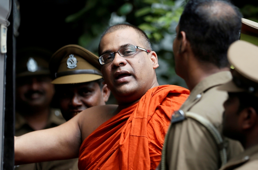 File photo shows Galagoda Aththe Gnanasara Thero, head of Buddhist group Bodu Bala Sena (BBS), walking towards a prison bus while accompanied by prison officers after he was sentenced by a court in Sri Lanka. — Reuters