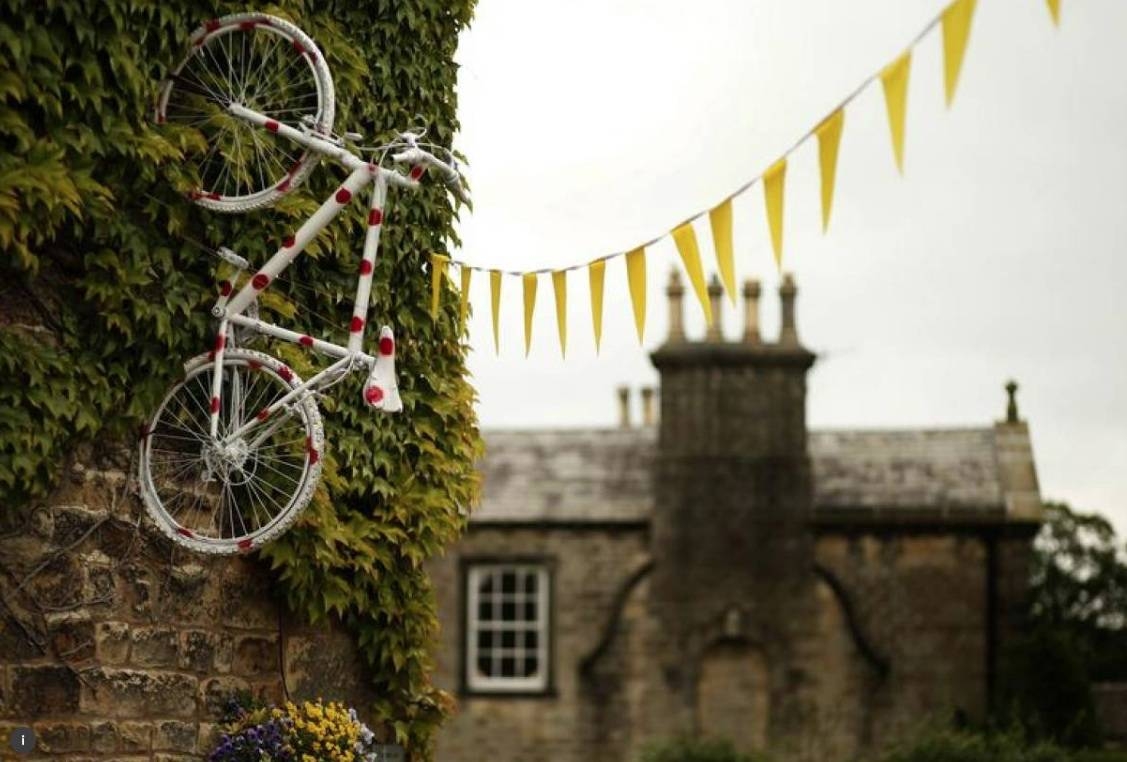 A bicycle decorated with polka dots hangs from the wall of a pub on the route of the Tour de France in Addingham, northern England, in this file photo. — Reuters