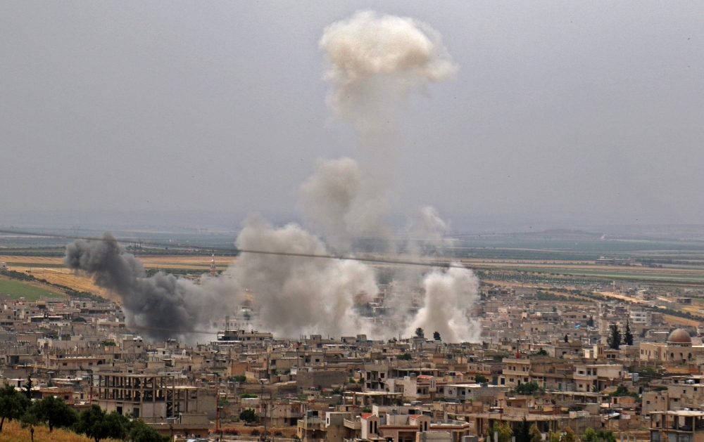 This picture taken on Thursday shows smoke plumes rising following reported Syrian government forces' bombardment on the town of Khan Sheikhun in the southern countryside of the rebel-held Idlib province. — AFP