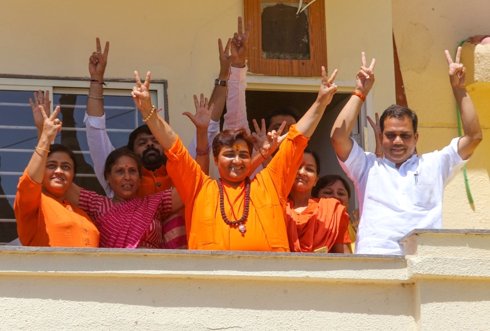 Indian Bharatiya Janata Party (BJP) candidate Pragya Singh Thakur, known as Sadhvi Pragya, gestures along with other BPJ supporters on the vote results day for India's general election at her residence in Bhopal on Thursday. — AFP