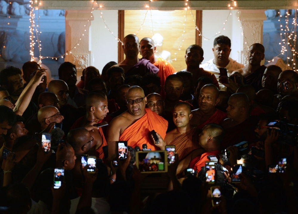 Sri Lankan General Secretary of the Bodu Bala Sena (BBS) Ven. Galagodaatte Gnanasara, center, speaks to the media at the Rukmalgama Temple in Rukmalgama, about 20 km from Colombo, on Thursday. — AFP