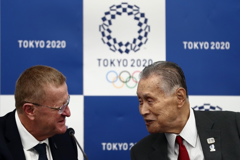 International Olympic Committee (IOC) vice president and chairman of the Coordination Commission for Tokyo 2020, John Coates (L) and Tokyo 2020 president Yoshiro Mori (R) chat during their joint press conference following the three-day session of the IOC Coordination Commission in Tokyo on Thursday. — AFP