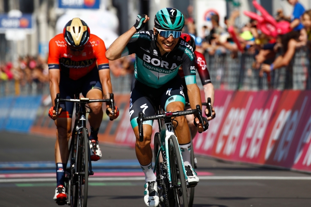 Winner Team Bora rider Italy's Cesare Benedetti (R) reacts as he crosses the finish line ahead of second-placed Team Bahrain rider Italy's Damiano Caruso (L) and third-placed Team Ineos rider Ireland's Eddie Dunbar (R) at the end of stage twelve of the 102nd Giro d'Italia - Tour of Italy - cycle race, 158kms from Cuneo to Pinerolo on Thursday. — AFP