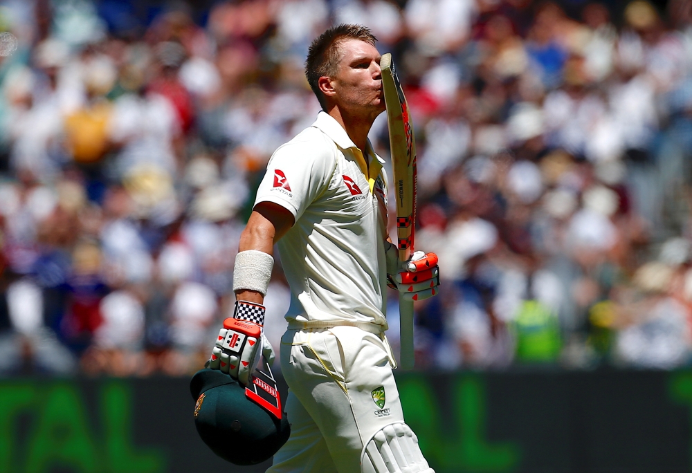 Australia's David Warner kisses his bat as he celebrates reaching his century during the first day of the fourth Ashes cricket test match in this file photo. — Reuters