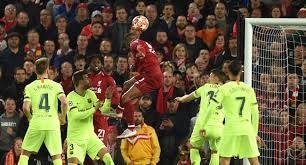 Liverpool's Dutch midfielder Georginio Wijnaldum (C) heads the ball to score their third goal against Barcelona on May 7, 2019, in the Champions League tie at Anfield in this file photo.