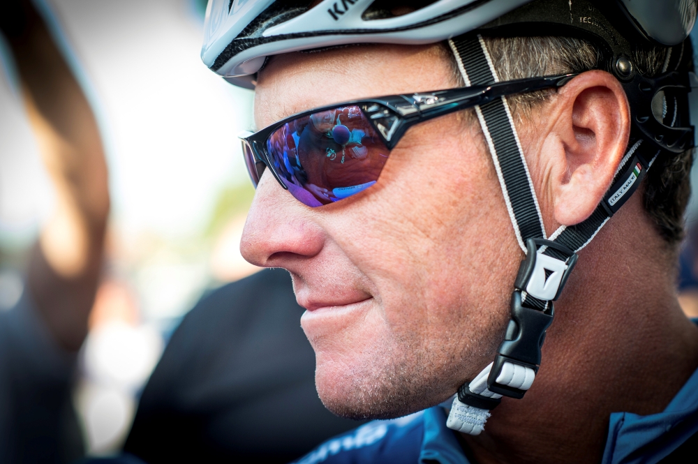 Cyclist Lance Armstrong of the US speaks to journalists as he leaves his bus before taking part in Geoff Thomas's 'One Day Ahead' charity event during a stage of the 102nd Tour de France cycling race from Muret to Rodez, France in this file photo. — Reuters