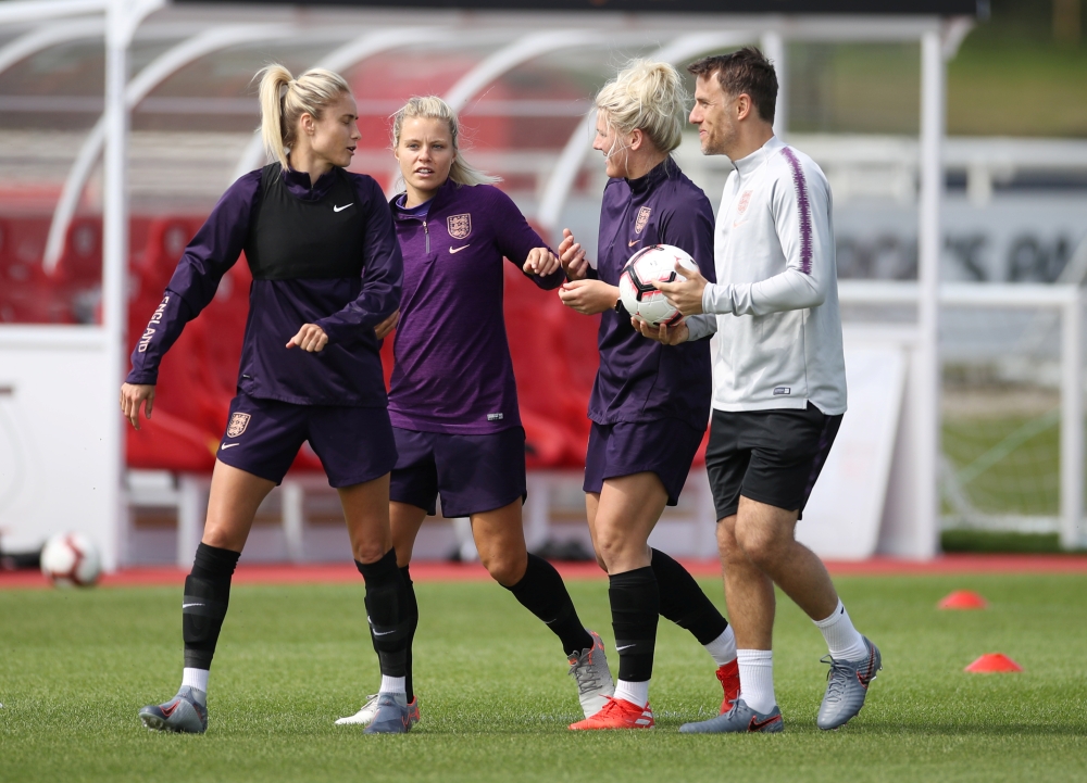 England manager Phil Neville with Millie Bright, Rachel Daly and Steph Houghton during training at the St. George’s Park, Burton upon Trent, Britain, on Friday. — Reuters