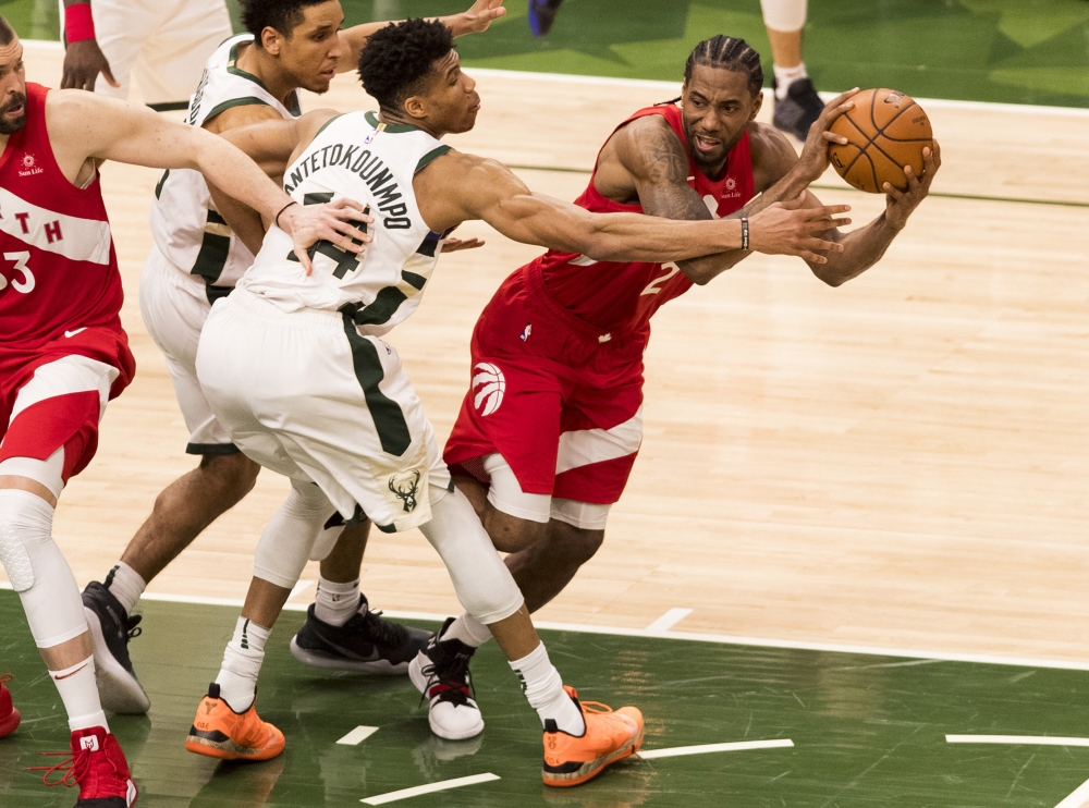 Toronto Raptors forward Kawhi Leonard (2) passes the ball as Milwaukee Bucks forward Giannis Antetokounmpo (34) defends during the fourth quarter in game five of the Eastern conference finals of the 2019 NBA Playoffs at Fiserv Forum. — Reuters