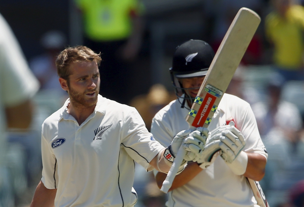 New Zealand's Kane Williamson (L) is applauded by teammate Ross Taylor as he celebrates reaching his century during the third day of the second cricket Test match against Australia at the WACA ground in Perth, Western Australia, on Nov. 15, 2015. — Reuters
