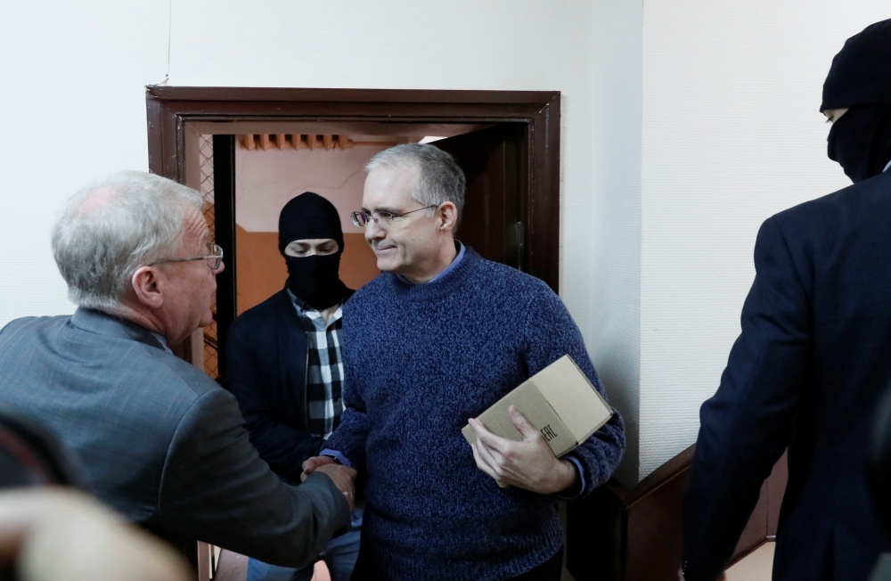 Former US Marine Paul Whelan, who was detained on suspicion of spying, is escorted inside a court building before a hearing regarding the extension of his detention, in Moscow, on Friday. — Reuters