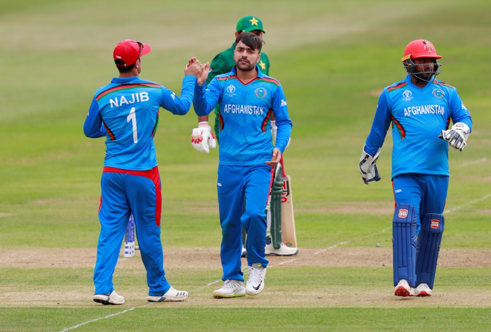 Afghanistan's Rashid Khan celebrates with Najibullah Zadran after taking the wicket of Pakistan's Sarfaraz Ahmed during the ICC Cricket World Cup warm-up match at the County Ground, Bristol, Britain, on Friday. — Reuters