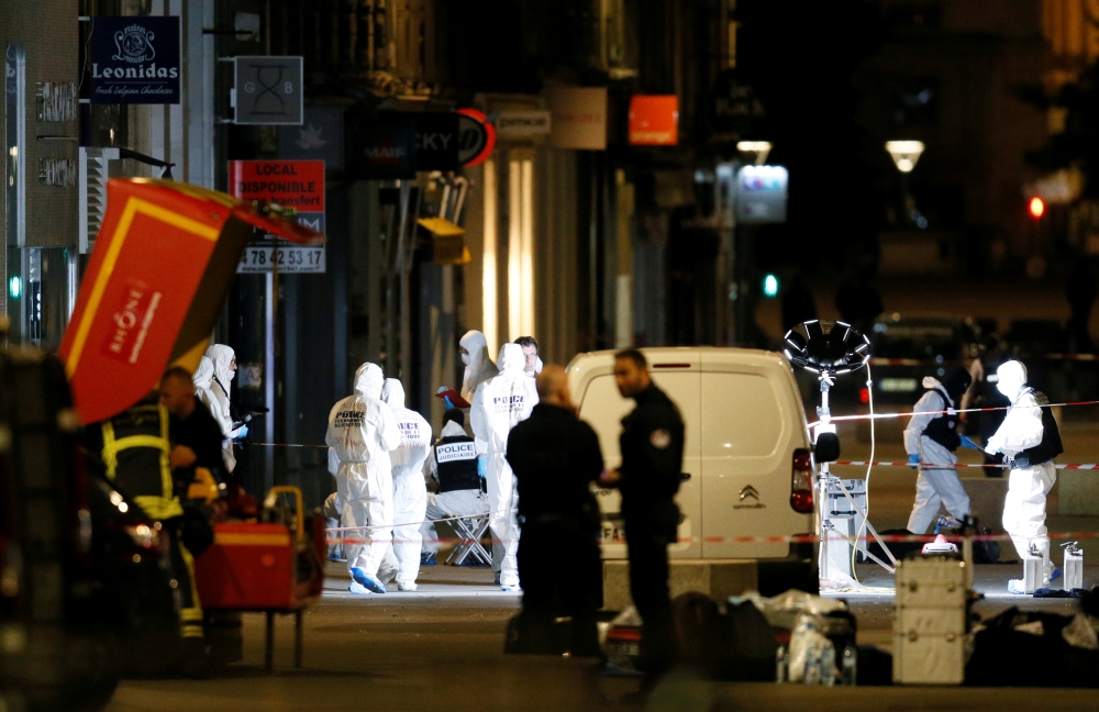 Forensic officers inspect the site of a suspected bomb attack in central Lyon, France May 24, 2019. - Reuters