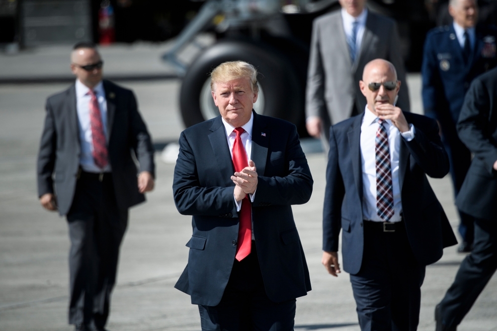 US President Donald Trump gestures as he walks on the tarmac at Elmendorf Air Force Base in Anchorage, Alaska, during a refuel stop en route to Japan on May 24. - AFP