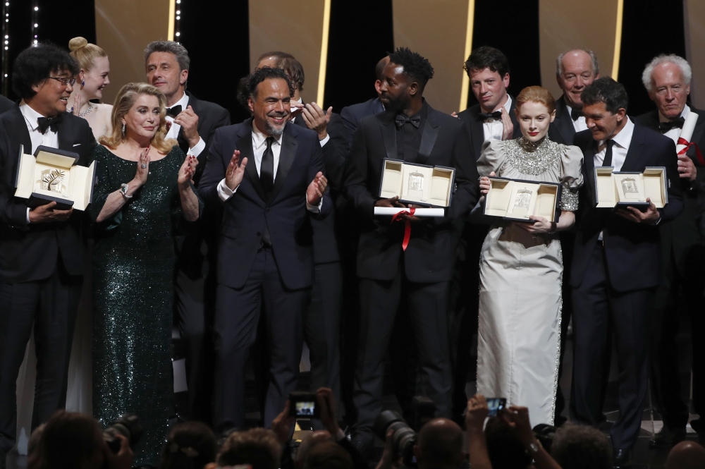Ladj Ly, Emily Beecham, Bong Joon-ho, Antonio Banderas pose on stage at Cannes on Saturday. — Reuters