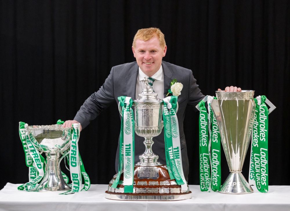 Celtic manager Neil Lennon celebrates winning the treble treble as he poses with the Scottish League cup, Scottish Cup and the Scottish Premiership trophy Soccer Football at Hampden Park, Glasgow, on Saturday. — Reuters