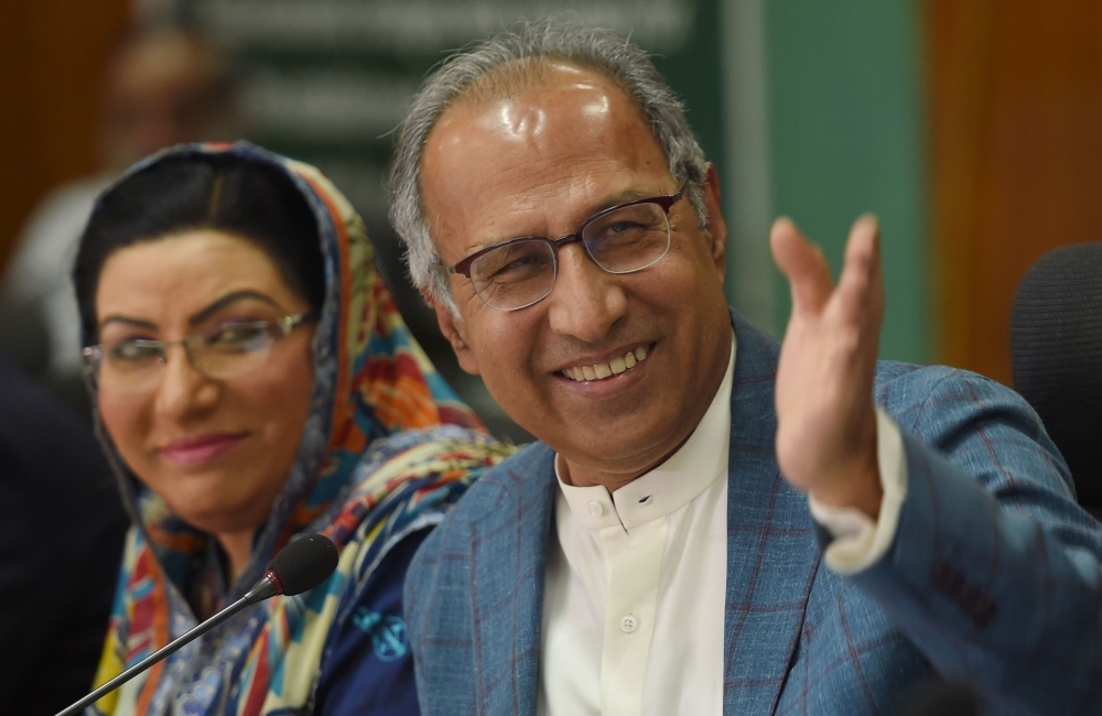 Adviser to Prime Minister Imran Khan on Finance, Revenue and Economic Affairs Abdul Hafeez Shaikh, left, gestures during a press conference next to special assistant to the Prime Minister for Information and Broadcasting Firdous Ashiq Awan, in Islamabad, on  Saturday. — AFP