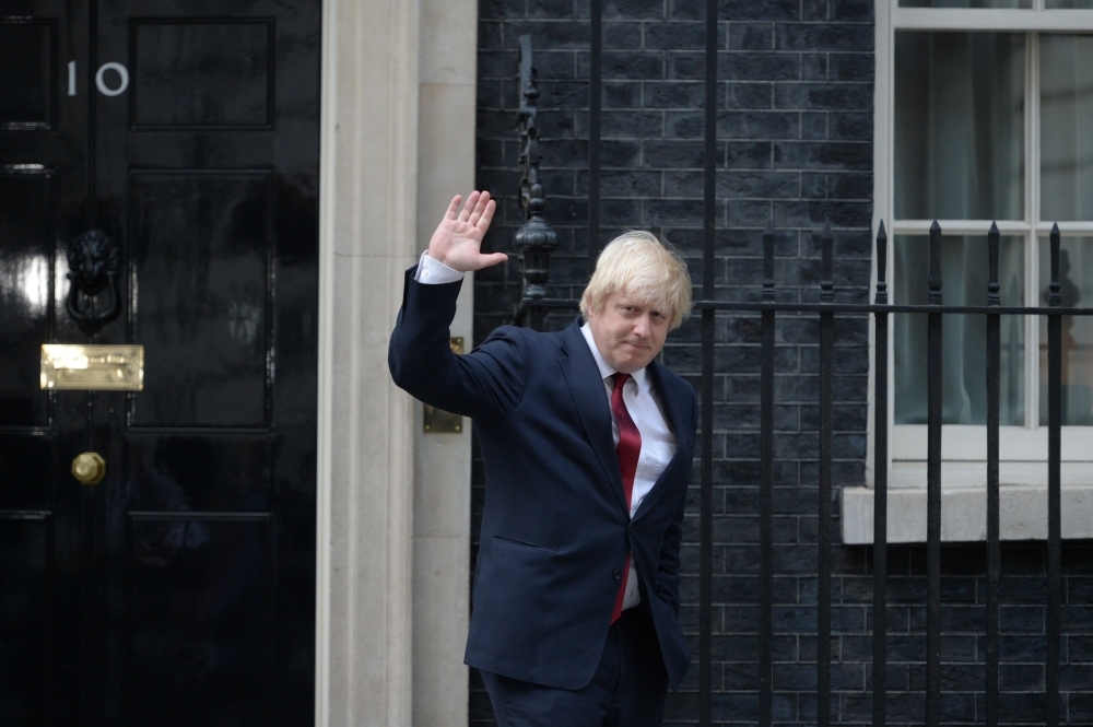 Newly appointed Foreign Secretary Boris Johnson waves as he leaves 10 Downing Street in central London on July 13, 2016 . - AFP 