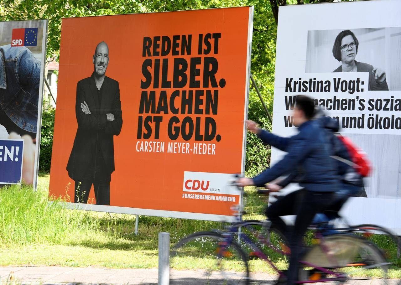 Election posters of Carsten Meyer-Heder, Germany's Christian Democrats Union (CDU) top candidate, and Kristina Vogt, top candidate of the German left-wing Die Linke party, are seen in Bremen, Germany May 4. — Reuters