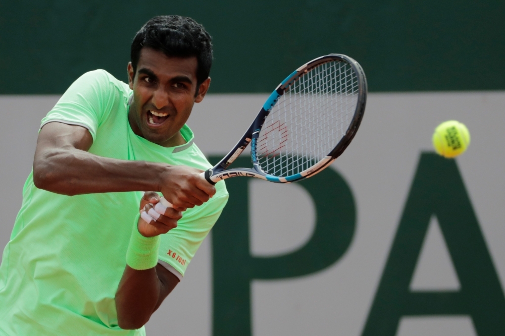 India's Prajnesh Gunneswaran returns the ball to Bolivia's Hugo Dellien during their men's singles first round match on day 1 of The Roland Garros 2019 French Open tennis tournament in Paris on Sunday. — AFP