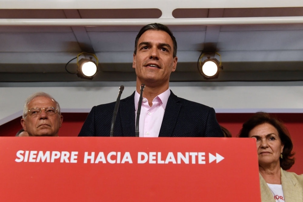Spanish prime minister, socialist Pedro Sanchez speaks during a press conference with current Spanish minister of foreign affairs and EU socialist candidate Josep Borrell (L), at the Spanish Socialist Party (PSOE) headquarters in Madrid on May 26. — AFP