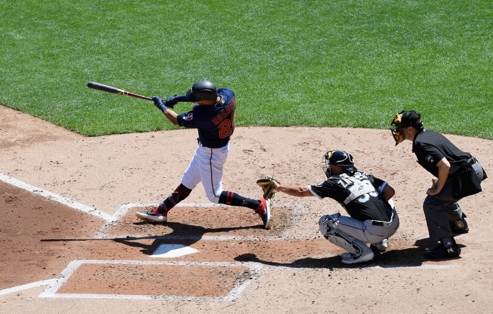 Eddie Rosario of the Minnesota Twins hits a three-run home run against the Chicago White Sox in the third inning of the game on Sunday at Target Field in Minneapolis, Minnesota. — AFP