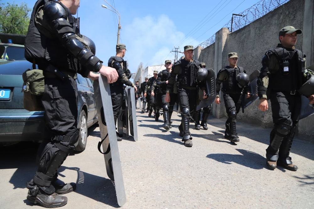 Ukrainian National Guard arrive at a penal colony during riots inside, in the southern city of Odessa, Ukraine, on Monday. — AFP