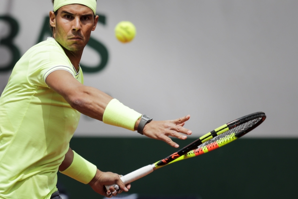 Spain's Rafael Nadal eyes the ball before playing a forehand return Germany's Yannick Hanfmann during their men's singles first round match on day two of The Roland Garros 2019 French Open tennis tournament in Paris on Monday. — AFP