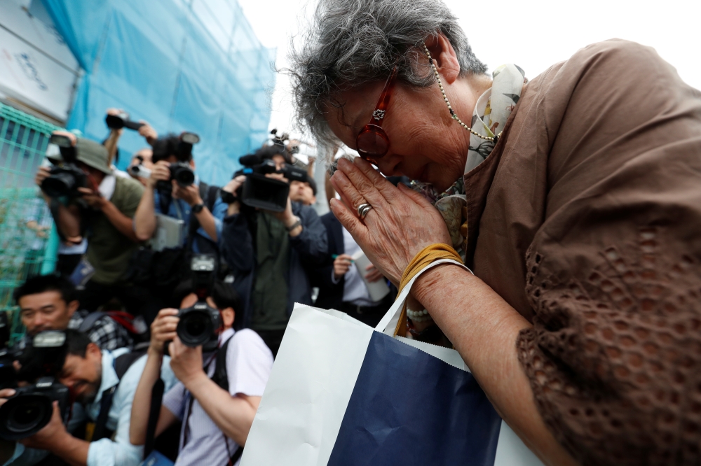 A local resident prays to mourn victims at the site where a stabbing occured in Kawasaki city, Japan May 28. — Reuters